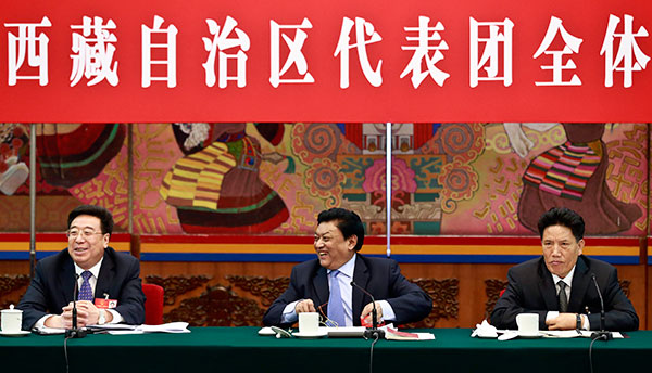 Padma Choling, head of the Standing Committee of the Tibet People's Congress (middle), Losang Jamcan, chairman of the autonomous region (right) and Wu Yingjie, deputy Party chief of the region, attend a panel discussion on Monday. [Photo/China Daily]