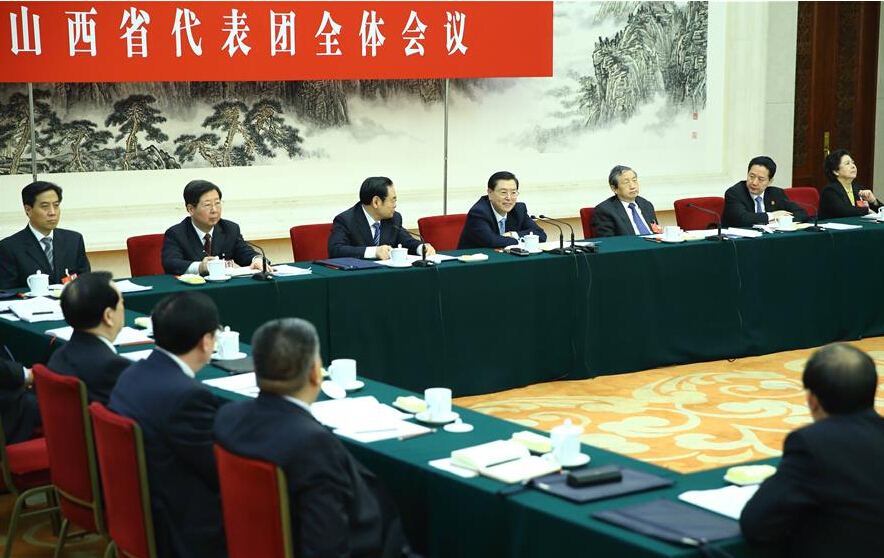 Zhang Dejiang (4th R, back), chairman of the Standing Committee of China's National People's Congress (NPC), joins a group deliberation of deputies from Shanxi Province to the annual session of the NPC in Beijing, capital of China, March 10, 2016. (Xinhua/Ding Haitao)