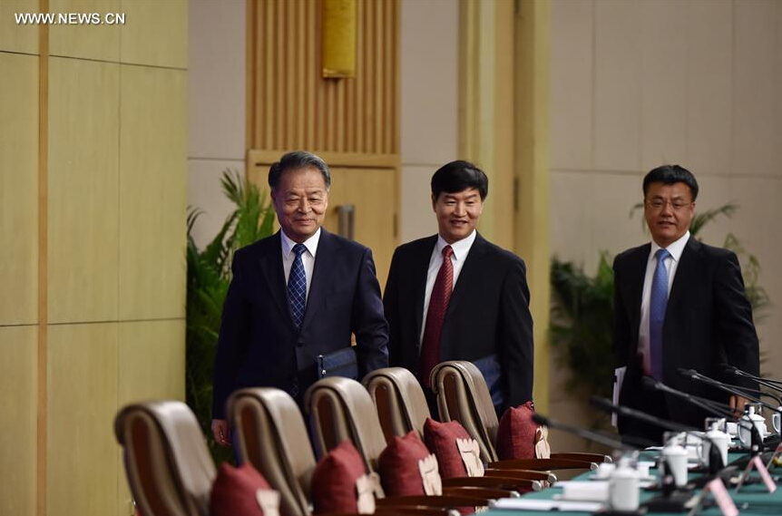 Chinese Minister of Transport Yang Chuantang (L), Director General of Transport Service Department of the Ministry of Transport Liu Xiaoming (C) and Director of Beijing Transportation Research Center Guo Jifu arrive for a press conference on reform and development of taxi on the sidelines of the fourth session of the 12th National People's Congress in Beijing, capital of China, March 14, 2016. (Xinhua/Li Xin)