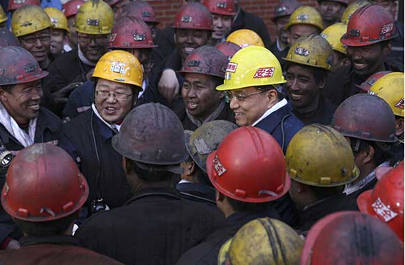 Premier Li Keqiang talks to miners before entering the 300-meter-deep Guandi Coal Mine in Taiyuan, Shanxi Province. He praised their hard work, saying the miners are 'not only the backbone of Shanxi, but also the backbone of China.'