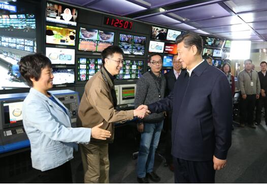 President Xi Jinping (R, front) shakes hands with staff members at the control room of China Central Television (CCTV) in Beijing, on Feb. 19, 2016.