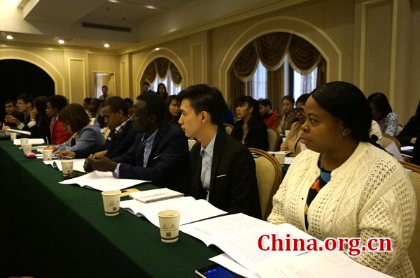 Foreign students from the International Master of Business Administration program listen to a presentation during a symposium with Shangluo local officials on March 23 in Shangluo City, Shaanxi Province. [Photo by Lin Liyao/China.org.cn]