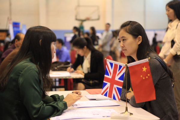 An overseas returnee attends an interview at a job fair in Beijing. [File photo]