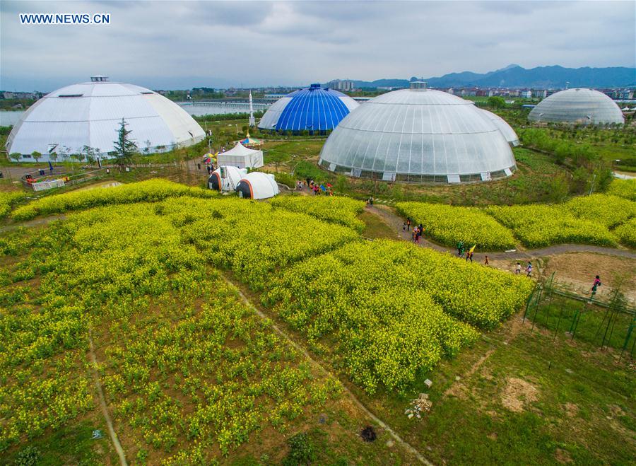 An aerial photo taken on April 9, 2016 shows people visiting dome greenhouses in Tiantai County, east China&apos;s Zhejiang Province.