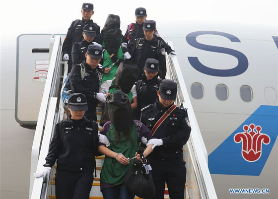 Chinese telecom fraud suspects deported from Kenya get off a plane after arriving at the Beijing Capital International Airport in Beijing, capital of China, April 13, 2016. [Photo/Xinhua]