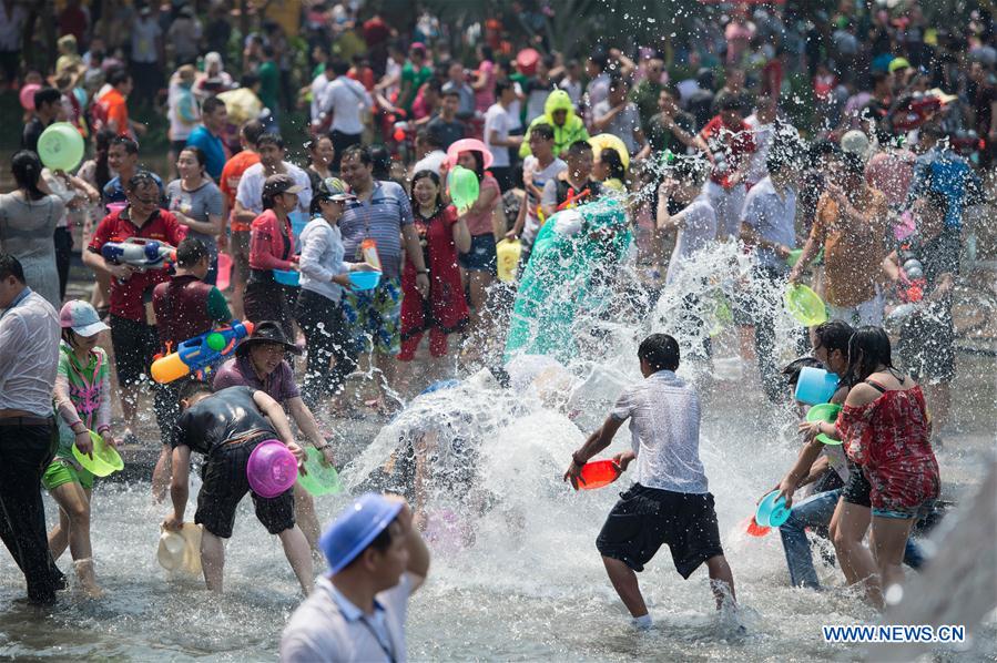 Local residents and tourists have fun during the water-splashing festival in Jinghong City, Dai Autonomous Prefecture of Xishuangbanna, southwest China's Yunnan Province, April 15, 2016. People splashed water to each other to express best regards during the water-splashing festival, which is also the New Year for the Dai ethnic group. [Photo/Xinhua]