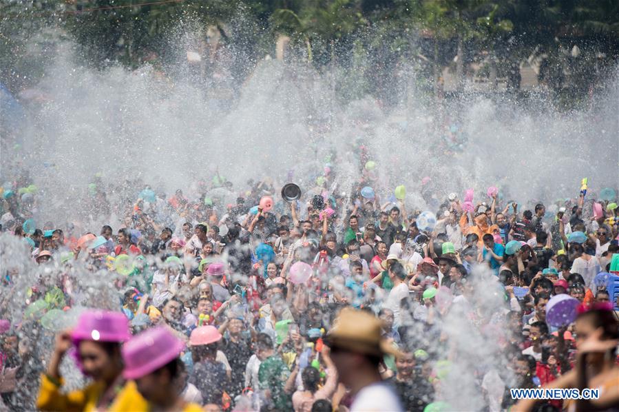 Local residents and tourists have fun during the water-splashing festival in Jinghong City, Dai Autonomous Prefecture of Xishuangbanna, southwest China's Yunnan Province, April 15, 2016. People splashed water to each other to express best regards during the water-splashing festival, which is also the New Year for the Dai ethnic group. [Photo/Xinhua]