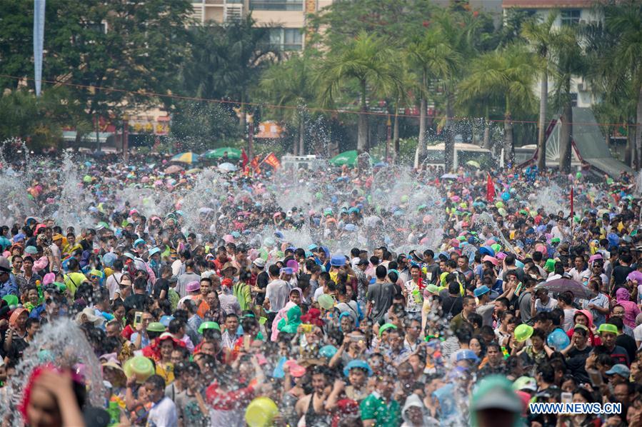 Local residents and tourists have fun during the water-splashing festival in Jinghong City, Dai Autonomous Prefecture of Xishuangbanna, southwest China's Yunnan Province, April 15, 2016. People splashed water to each other to express best regards during the water-splashing festival, which is also the New Year for the Dai ethnic group. [Photo/Xinhua]