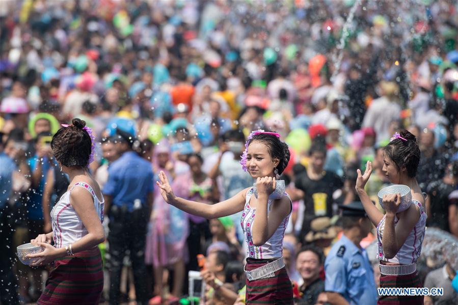 Ladies of Dai ethnic group dance during the water-splashing festival in Jinghong City, Dai Autonomous Prefecture of Xishuangbanna, southwest China's Yunnan Province, April 15, 2016. People splashed water to each other to express best regards during the water-splashing festival, which is also the New Year for the Dai ethnic group. [Photo/Xinhua]