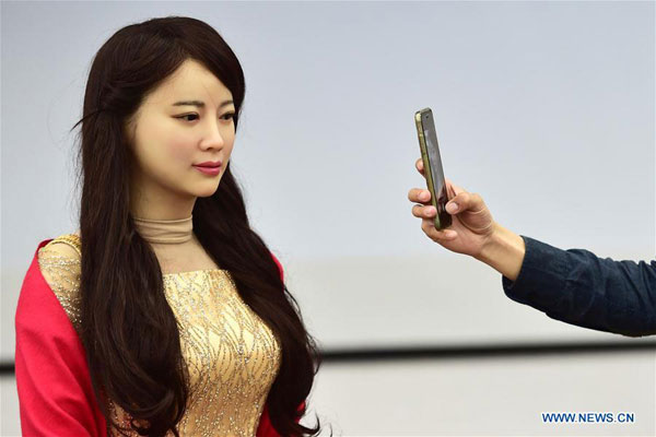 An interactive robot named Jiajia, who looks very much like a real woman, is unveiled by the University of Science and Techonology of China in Hefei, capital of East China's Anhui province, April 15, 2016. [Photo: Xinhua]