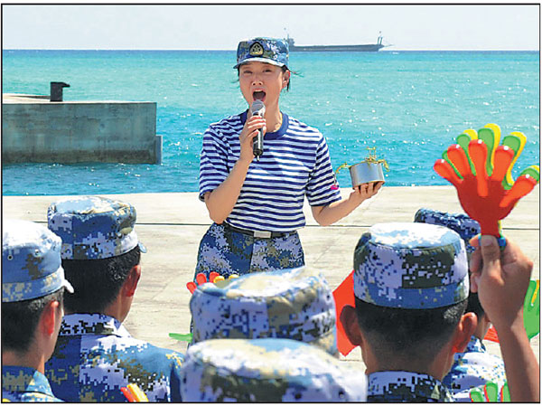 Soprano Song Zuying performs for soldiers and construction workers on Chigua Reef during a show in the South China Sea on Wednesday organized by the PLA Navy.Gan Jun / For China Daily 
