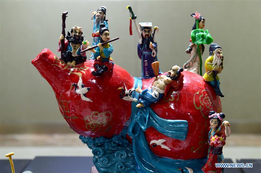 A delicate dough figurine work is presented in an exhibition hall during a craft workshop in Jinan, capital of east China's Shandong Province, May 5, 2016. Traditional dough figurine has been listed as China's national intangible cultural heritage. [Photo/Xinhua]