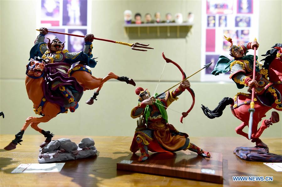 A delicate dough figurine work is presented in an exhibition hall during a craft workshop in Jinan, capital of east China's Shandong Province, May 5, 2016. Traditional dough figurine has been listed as China's national intangible cultural heritage. [Photo/Xinhua]