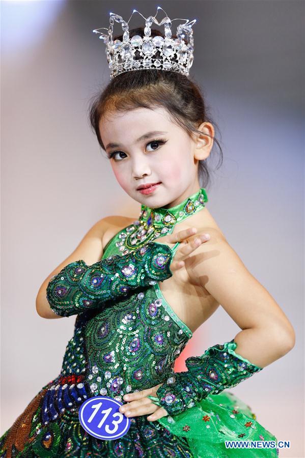 A participant presents a creation at a mini model contest during the 16th China (Qingdao) International Fashion Week in Qingdao, east China's Shandong Province, May 14, 2016. More than 200 children from all over the country took part in the contest. [Photo/Xinhua]