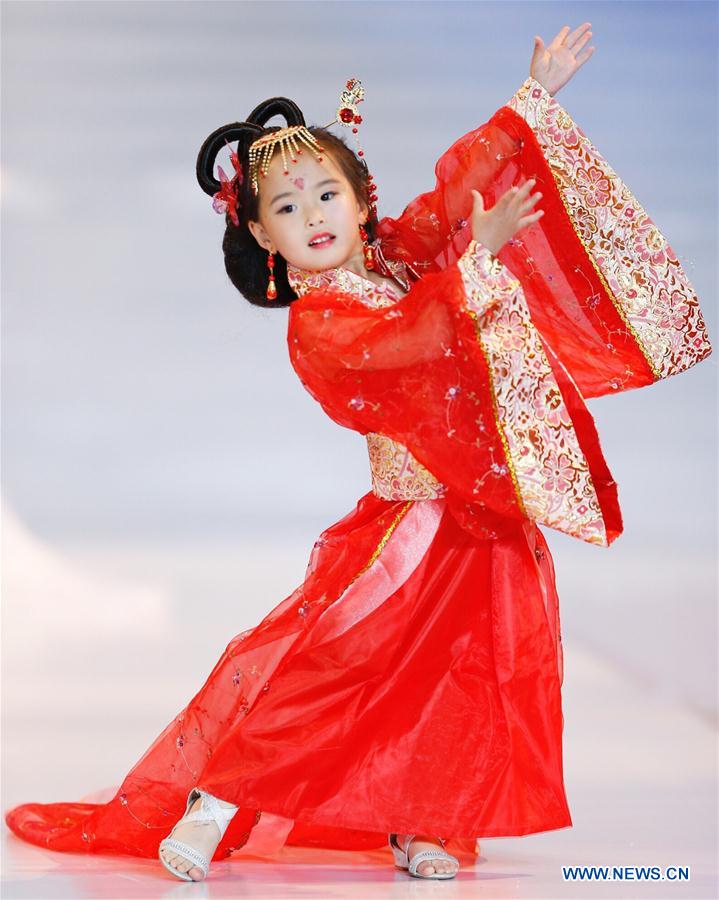 A participant presents a creation at a mini model contest during the 16th China (Qingdao) International Fashion Week in Qingdao, east China's Shandong Province, May 14, 2016. More than 200 children from all over the country took part in the contest. [Photo/Xinhua]