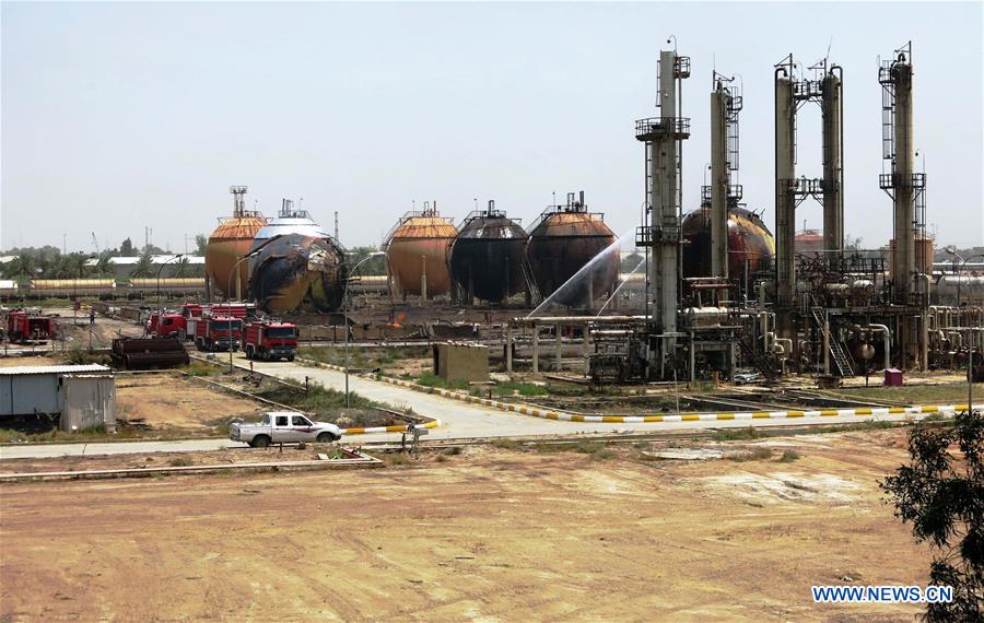 Firefighters work at a gas plant after it was attacked by Islamic State (IS) suicide bombers, in Taji area, northern suburb of the Iraqi capital of Baghdad, May 15, 2016. Up to seven security members and civilian workers were killed and 24 others wounded on Sunday, as Iraqi security forces foiled an attempt by Islamic State (IS) suicide bombers to seize and destroy a gas plant in a northern suburb of Baghdad, an Interior Ministry source said. [Photo/Xinhua]