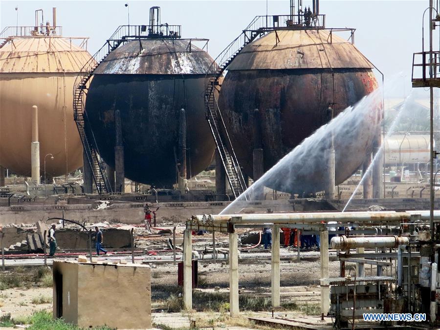 Firefighters work at a gas plant after it was attacked by Islamic State (IS) suicide bombers, in Taji area, northern suburb of the Iraqi capital of Baghdad, May 15, 2016. Up to seven security members and civilian workers were killed and 24 others wounded on Sunday, as Iraqi security forces foiled an attempt by Islamic State (IS) suicide bombers to seize and destroy a gas plant in a northern suburb of Baghdad, an Interior Ministry source said. [Photo/Xinhua]