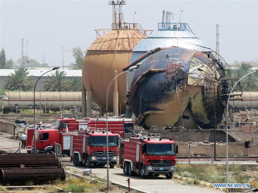 Fire engines are seen at a gas plant after it was attacked by Islamic State (IS) suicide bombers, in Taji area, northern suburb of the Iraqi capital of Baghdad, May 15, 2016. Up to seven security members and civilian workers were killed and 24 others wounded on Sunday, as Iraqi security forces foiled an attempt by Islamic State (IS) suicide bombers to seize and destroy a gas plant in a northern suburb of Baghdad, an Interior Ministry source said. [Photo/Xinhua]