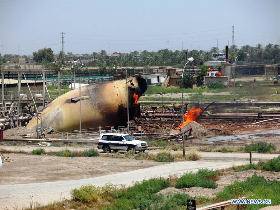 A storage gas tank is on fire at a gas plant after it was attacked by Islamic State (IS) suicide bombers, in Taji area, northern suburb of the Iraqi capital of Baghdad, May 15, 2016. Up to seven security members and civilian workers were killed and 24 others wounded on Sunday, as Iraqi security forces foiled an attempt by Islamic State (IS) suicide bombers to seize and destroy a gas plant in a northern suburb of Baghdad, an Interior Ministry source said. [Photo/Xinhua]