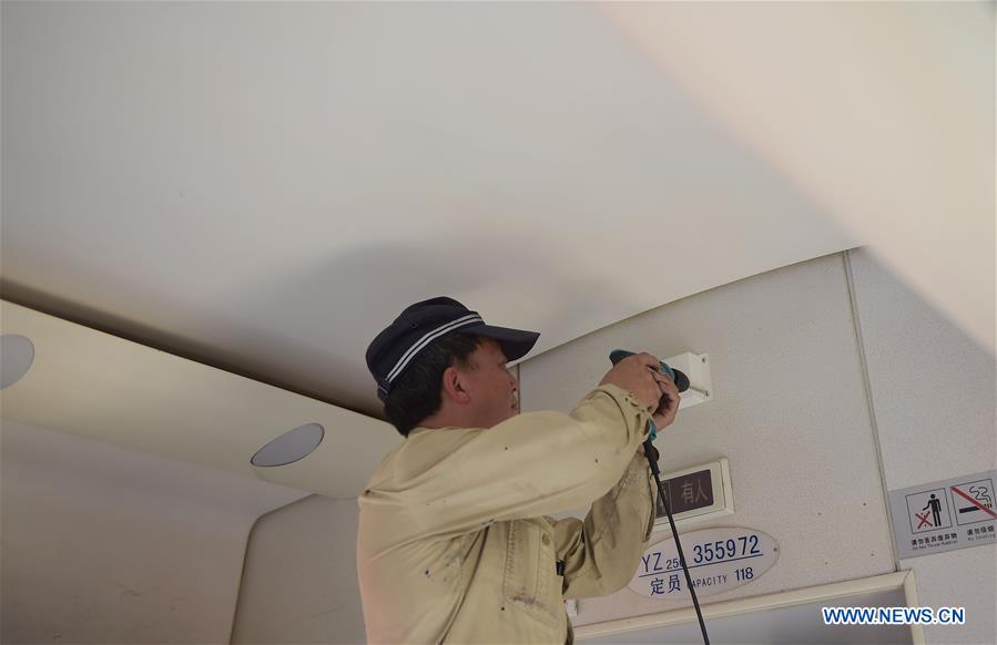 A worker installs WiFi device on a train administrated by the railway bureau of Chengdu, capital of southwest China&apos;s Sichuan Province, May 20, 2016. This year WiFi would be installed on 100 non-high-speed trains run by Chengdu railway bureau in order to enrich the experience of passengers. (Xinhua/Xue Yubin) 