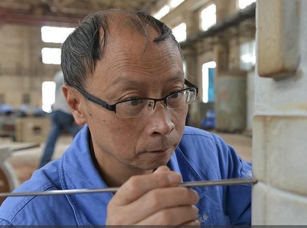 Mao Lasheng, a sand molder working for the country's largest missile manufacturer, has seen his products paraded in Tian'anmen Square four times. [Photo/Xinhua]