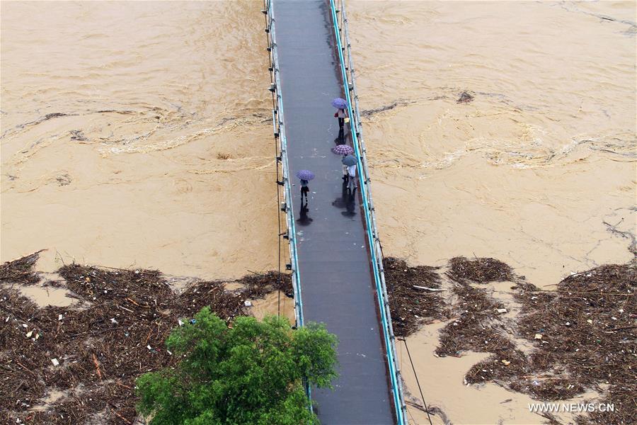 Flood water approaches a bridge surface in Shunchang County of Nanping City, southeast China&apos;s Fujian Province, June 18, 2016. Torrential railfall has pushed water level of a branch of the Minjiang River to surpass its warning line, flooding residential quarters and interrupting traffic in Shunchang County. (Xinhua/Chen Baicai)