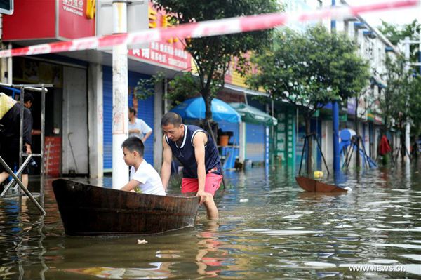 Photo taken on July 3, 2016 shows the scene of a waterlogged street in Xuancheng City, east China's Anhui Province. Many regions in Anhui were flooded due to heavy rainfall in recent days. [Photo/Xinhua]