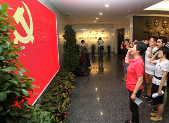 Members of the Communist Party of China (CPC) recite the oath to join the CPC at the site where the CPC held its first national congress in Shanghai, July 1, 2016. The site reopened to the public after a major refurbishment and expansion on July 1, the 95th anniversary of the Party's founding.