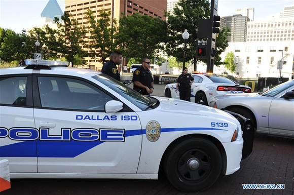 An FBI detective works at the scene of shooting of police personnel in Dallas, the United States, July 8, 2016. Five police personnel were killed and seven others injured as two snipers opened fire at them during a protest against police shootings of two African-American men in Louisiana and Minnesota, in downtown Dallas Thursday night. [Xinhua]    