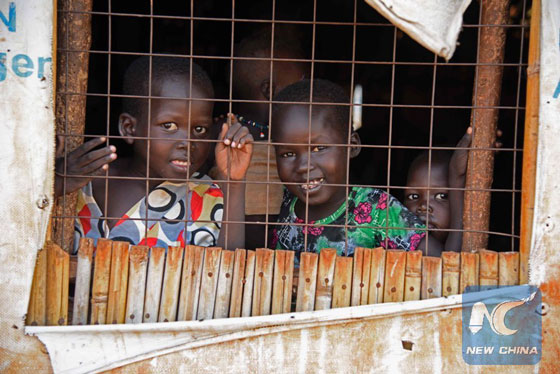 South Sudanese refugee children look through a window at the Nyumanzi transit centre in Adjumani on July 13, 2016. [Photo/Xinhua]