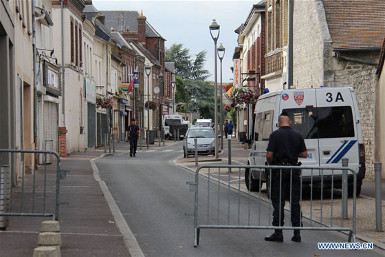 Police stand guard near the church where a priest was killed in Saint-Etienne du Rouvray, France on July 26, 2016. [Photo/Xinhua]