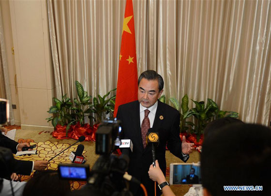 Chinese Foreign Minister Wang Yi (C) speaks to the press after the meetings in Vientiane, capital of Laos, on July 26, 2016. [Photo/Xinhua]