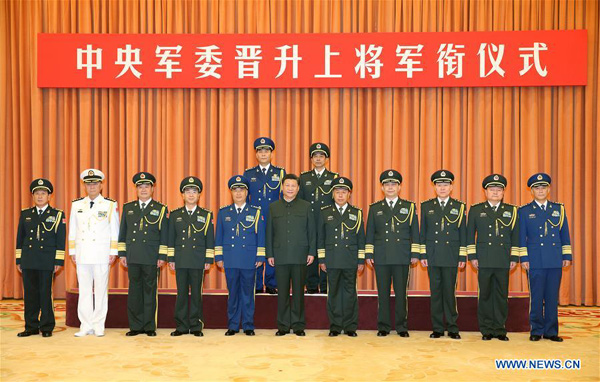 Chinese President Xi Jinping (C, front), who is also chairman of the Central Military Commission (CMC), and other military leaders pose for a group photo with two senior military officers, who are promoted to the rank of general, the highest rank for officers in active service, after a promotion ceremony in Beijing, capital of China, July 29, 2016. Xi Jinping presented the officers with certificates of command on Friday. (Xinhua/Li Gang) 