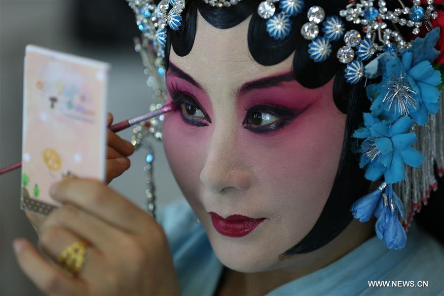 An actress of Hebei Bangzi applies make-up before a performance during 2016 China Hebei Bangzi Festival in Gu&apos;an, north China&apos;s Hebei Province, July 29, 2016. Hebei Bangzi, or Hebei Opera, is the main type of opera in Hebei Province which became popular in Qing Dynasty (1644-1911). Like Peking Opera, it&apos;s a traditional Chinese opera which combines music, vocal performance, dance, acrobatics and etc. (Xinhua/Cai Yang) 
