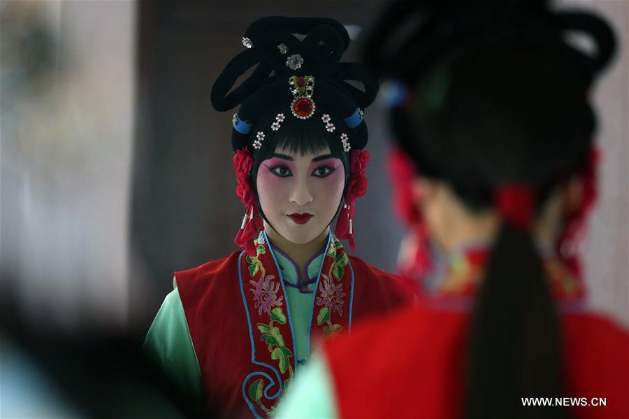 An actress of Hebei Bangzi prepares before a performance during 2016 China Hebei Bangzi Festival in Gu&apos;an, north China&apos;s Hebei Province, July 29, 2016. Hebei Bangzi, or Hebei Opera, is the main type of opera in Hebei Province which became popular in Qing Dynasty (1644-1911). Like Peking Opera, it&apos;s a traditional Chinese opera which combines music, vocal performance, dance, acrobatics and etc. (Xinhua/Cai Yang) 