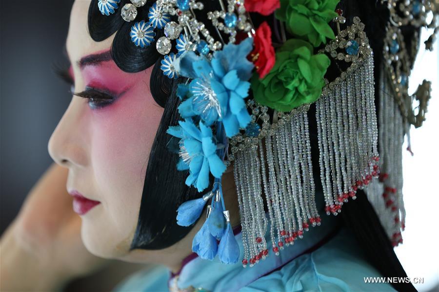 An actress of Hebei Bangzi prepares before a performance during 2016 China Hebei Bangzi Festival in Gu&apos;an, north China&apos;s Hebei Province, July 29, 2016. Hebei Bangzi, or Hebei Opera, is the main type of opera in Hebei Province which became popular in Qing Dynasty (1644-1911). Like Peking Opera, it&apos;s a traditional Chinese opera which combines music, vocal performance, dance, acrobatics and etc. (Xinhua/Cai Yang) 