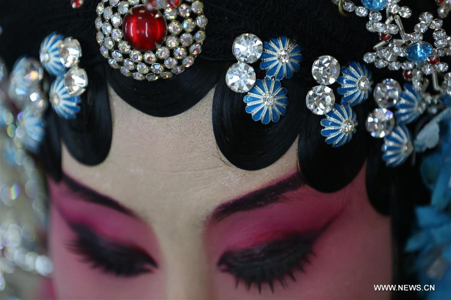 An actress of Hebei Bangzi prepares before a performance during 2016 China Hebei Bangzi Festival in Gu&apos;an, north China&apos;s Hebei Province, July 29, 2016. Hebei Bangzi, or Hebei Opera, is the main type of opera in Hebei Province which became popular in Qing Dynasty (1644-1911). Like Peking Opera, it&apos;s a traditional Chinese opera which combines music, vocal performance, dance, acrobatics and etc. (Xinhua/Cai Yang) 