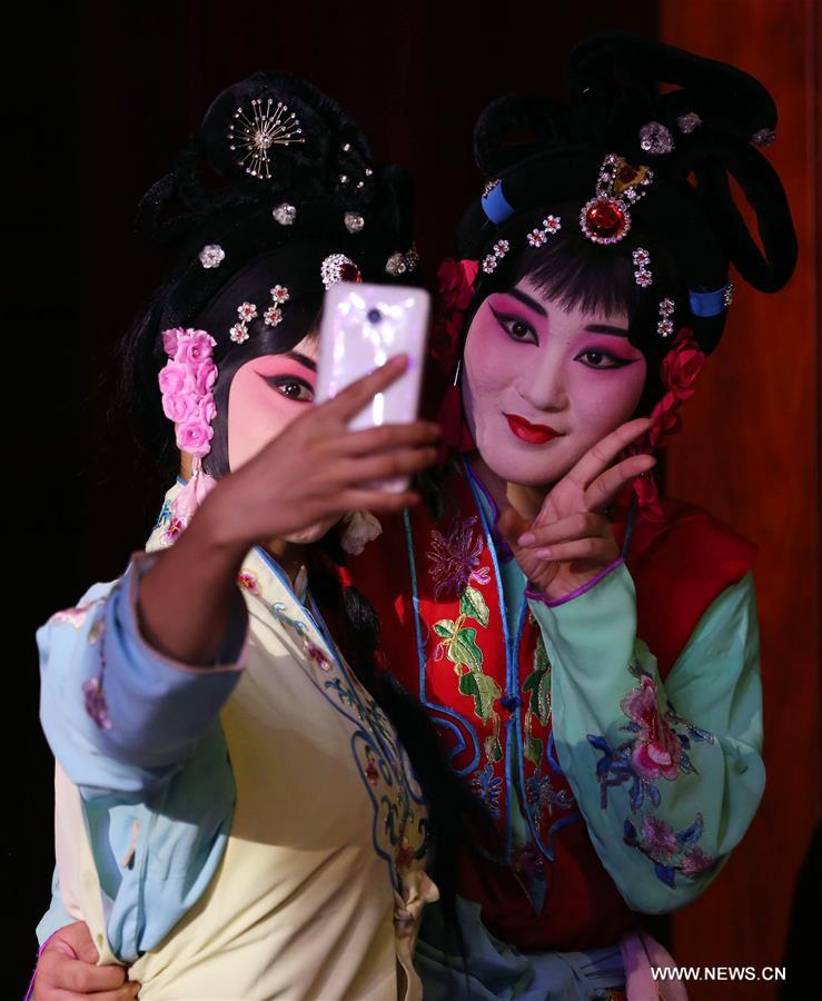 Actresses of Hebei Bangzi take a selfie picture backstage during 2016 China Hebei Bangzi Festival in Gu&apos;an, north China&apos;s Hebei Province, July 29, 2016. Hebei Bangzi, or Hebei Opera, is the main type of opera in Hebei Province which became popular in Qing Dynasty (1644-1911). Like Peking Opera, it&apos;s a traditional Chinese opera which combines music, vocal performance, dance, acrobatics and etc. (Xinhua/Cai Yang) 