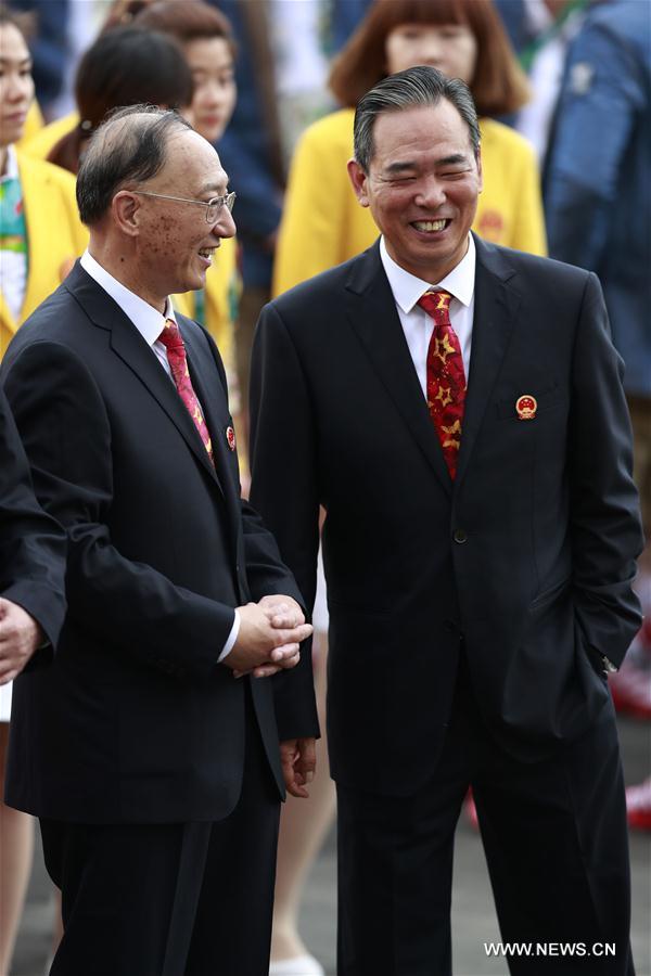 Chef de mission of Chinese delegation and director of General Administration of Sports of China Liu Peng (L), and deputy chef de mission of Chinese delegation Cai Zhenhua attend the flag-raising ceremony at the Olympic Village in Rio de Janeiro, Brazil, on Aug. 3, 2016. (Xinhua/Ren Zhenglai) 