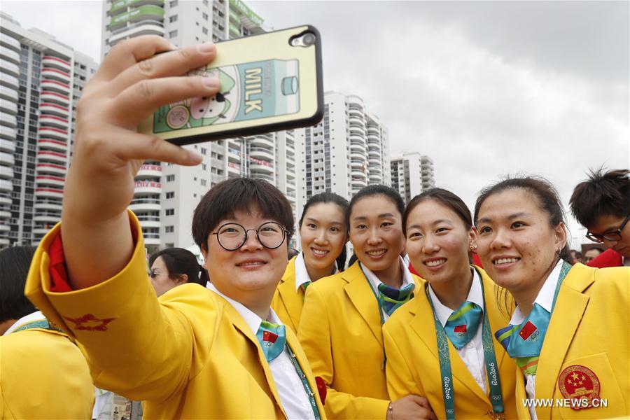 Members of the Chinese delegation pose for photos prior to the flag-raising ceremony at the Olympic Village in Rio de Janeiro, Brazil, on Aug. 3, 2016. (Xinhua/Shen Bohan) 