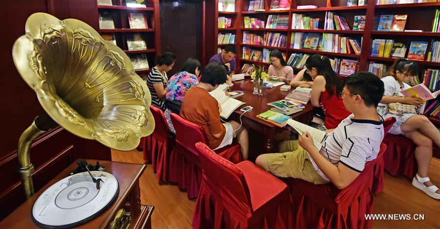 People read at Goethe Bookstore in Shenyang, northeast China's Liaoning Province, Aug. 18, 2016. Goethe Bookstore, a 24-hour bookstore featuring books of social science, original books of German, French, and English, vinyl records, exotic gifts, art performances and reading clubs, opened Thursday in an ancient building at Zhongshan Square in Shenyang. [Xinhua]
