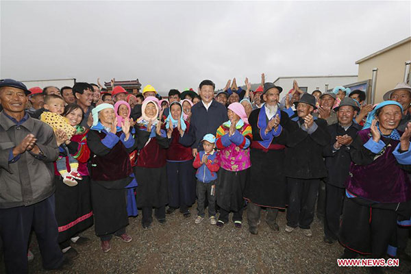 Chinese President Xi Jinping poses for a group photo with villagers in a village of Wushi Township of Huzhu Tu Autonomous County in Haidong, Qinghai province, Aug 23, 2016. [Photo/Xinhua] 