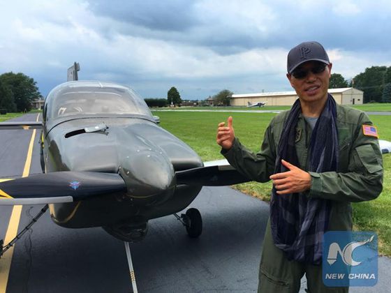David Hu poses for photos after completing a test flight with his home-made plane in Naperville, west suburb of Chicago, the United States, on Aug. 28, 2016. [Photo/Xinhua]