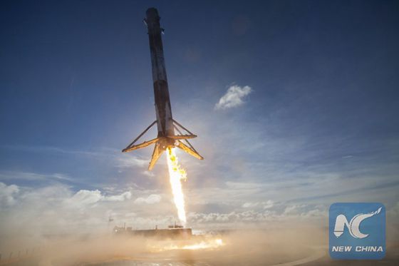 In this May 27, 2016 photo made available by SpaceX, their Falcon rocket booster lands on a platform in the Atlantic Ocean after launching a satellite into orbit. The company says it can save considerable time and money by reusing the big, expensive parts. [Photo/Xinhua]
