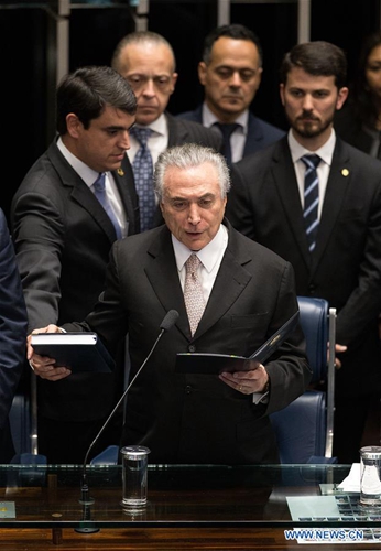 Michel Temer (front) takes oath at the senate in Brasilia, Brazil, Aug. 31, 2016. Temer was sworn in as the new president of Brazil on Wednesday afternoon, after Dilma Rousseff was stripped of the presidency by the Senate in an impeachment trial. [Photo/Xinhua]