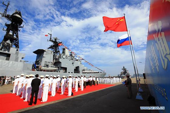 Officers and soldiers of Chinese Navy hold a welcome ceremony as a Russian fleet arrive at a port in Zhanjiang, south China's Guangdong Province, Sept. 12, 2016. [Photo/Xinhua] 
