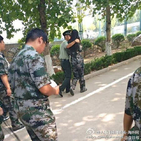 The photo from Sina Weibo showing a military training instructor hugging a first year student on the campus of Qingdao Technological University. [Photo: Weibo]
