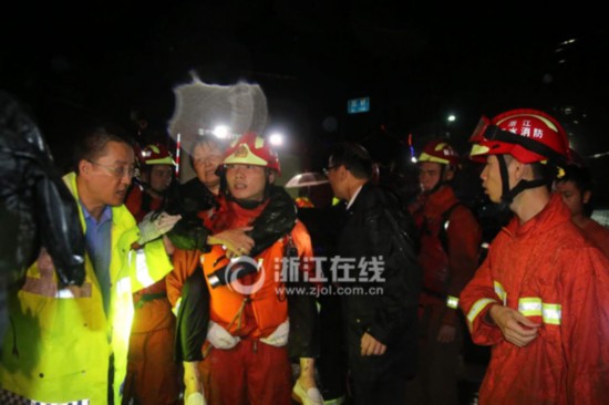Firefighters and police evacuate residents stranded in a village in the eastern province of Zhejiang on September 28, 2016.