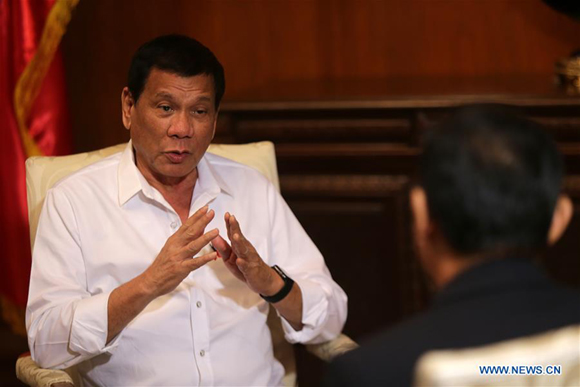 Philippine President Rodrigo Duterte (L) speaks during an interview with Xinhua News Agency in Manila, the Philippines, Oct. 13, 2016. Duterte has said that his country expects to boost traditional friendship with China and further bilateral trade and economic cooperation. (Xinhua/Rouelle Umali)