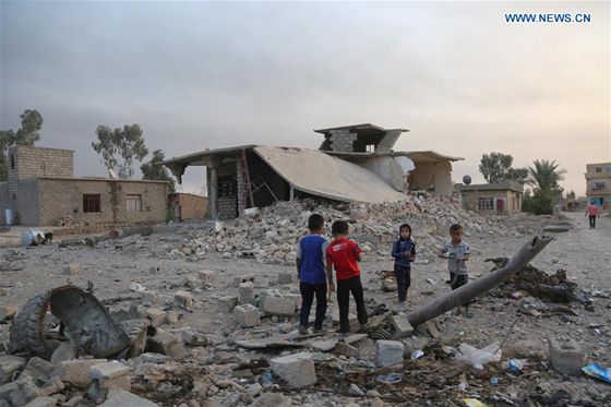 Children play games in front a building that was destroyed in battles between Iraqi army and Islamic State militants in Qayyarah, southern Mosul, Iraq on Oct. 17, 2016. [Photo/Xinhua]